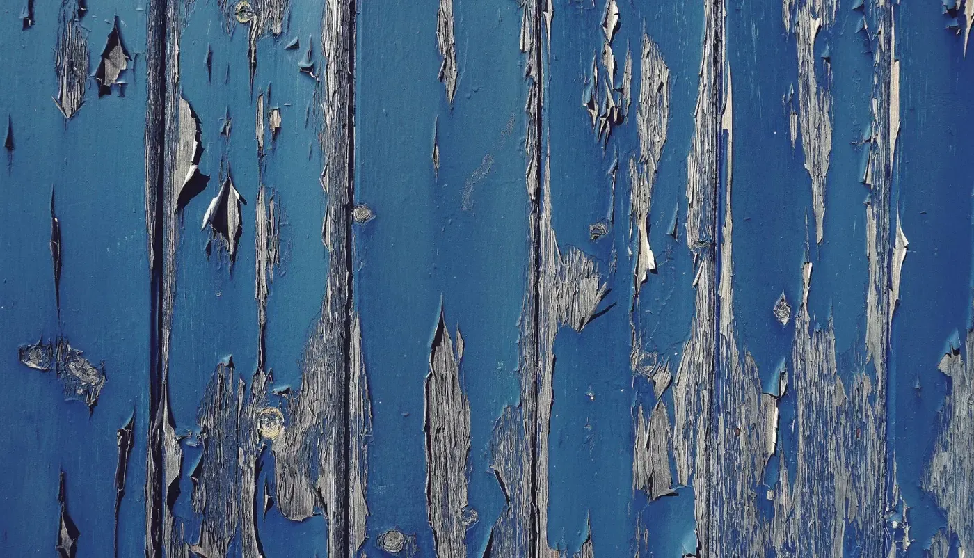 Peeling paint on old wood siding in Syracuse, New York